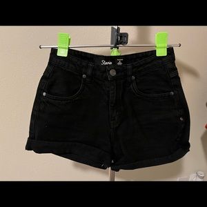 Black high rise denim shorts ft belt loops, a 4-pocket construction & cuffed hem